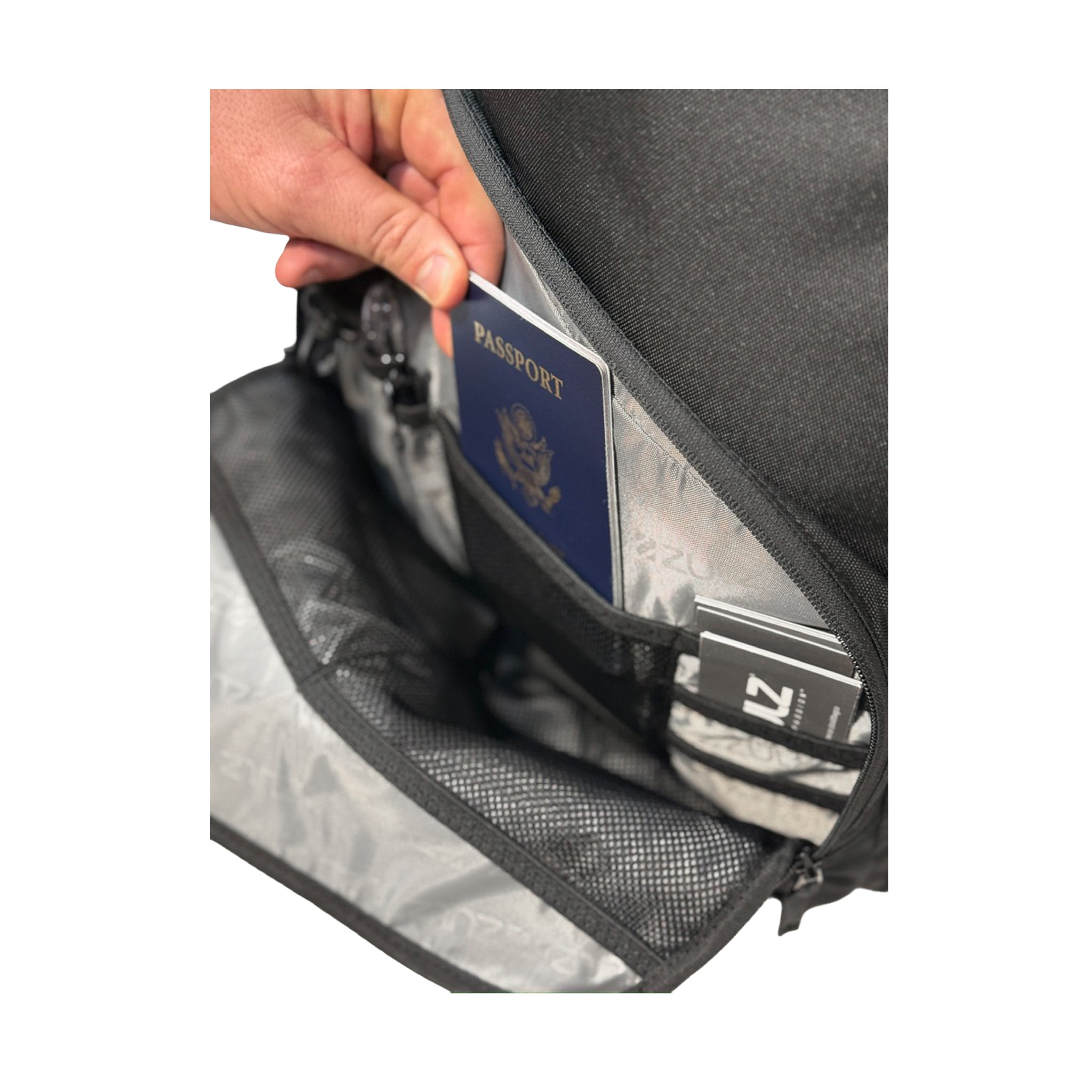 Person opening a black travel bag to reveal a passport and other documents.