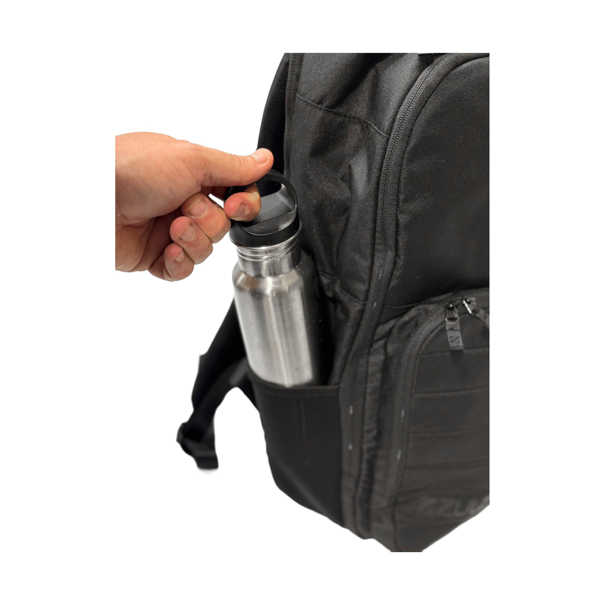 Person placing a silver water bottle into a black backpack